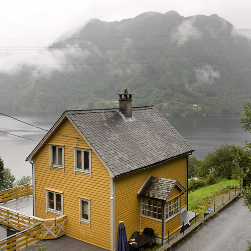 road roof chimney cloud house mist mountain tree water yellow norway fog architecture fence outdoors day waterfront nopeople remote fjord nordic scandinavia gable scenics tranquilscene rooftile traveldestinations highangleview norwegianculture sorfjord squareimage builtstructure