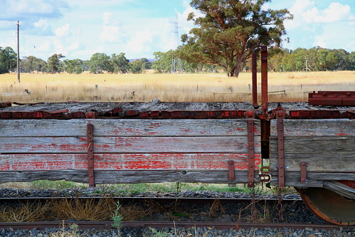 victoria tracks timber texture surface sky sidings fenceposts rust rural rollingstock red railway railside rail peelingpaint landscape iron industrial grass freight clouds australia disused