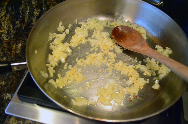 Onion and garlic cooking in olive oil in a skillet.