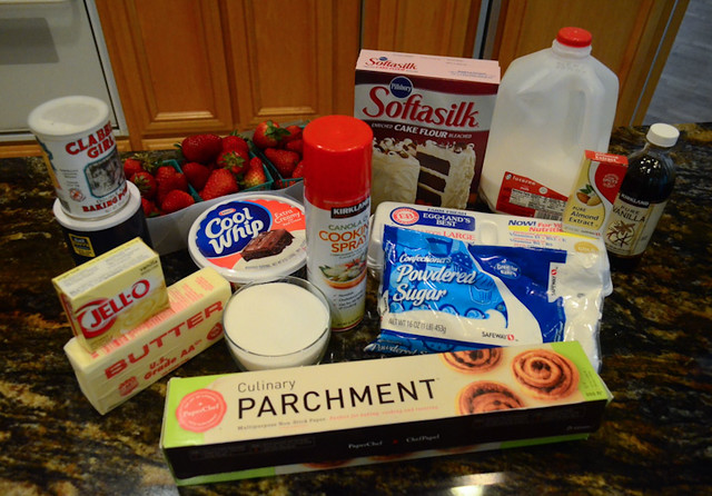 All the ingredients required for strawberries and cream cake arranged on a counter top.