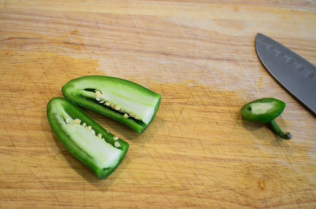 A jalapeno cut in half, showing the seeds that are inside.