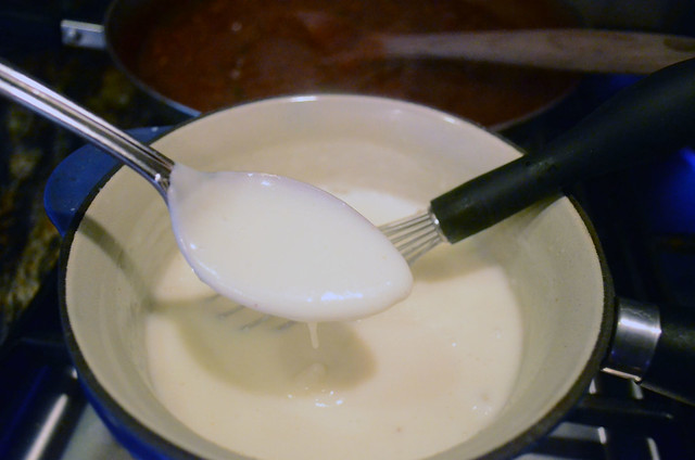 A spoonful of the thickened bechamel sauce.