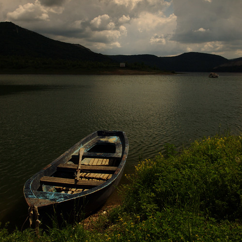 lake storm rain clouds boat bulgaria shore