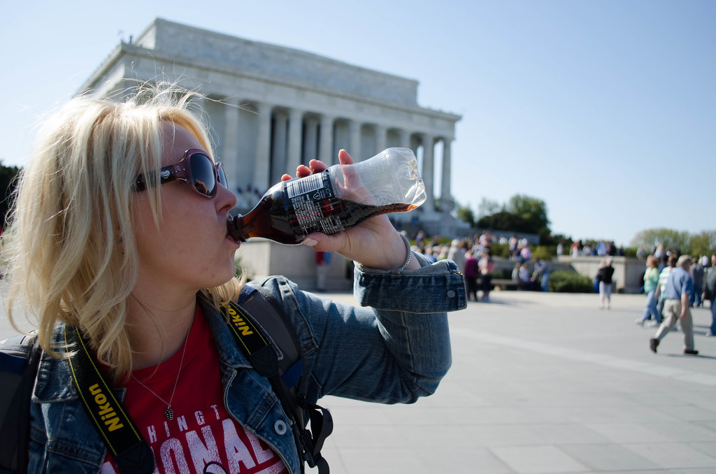 Theresa, drinking a diet Coke in front of the Lincoln Memorial