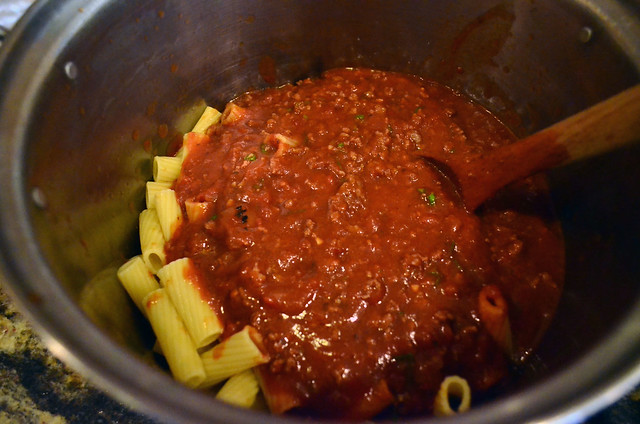 The meat sauce is added to the cooked rigatoni.
