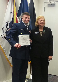 Petty Officer 1st Class James Coppola, a native of Terryville, Conn., is recognized as the Coast Guard 9th District staff's 2013 Enlisted Person of the Year as well as the Enlisted Person of the Quarter for the first quarter of 2014 by Catherine Owen, president of the Navy League Cleveland Council, April 4, 2014. Coppola was recognized for his outstanding performance as an operations specialist in the 9th District's Command Center as well as his efforts in community service.  U.S. Coast Guard photo by Chief Petty Officer Dave Foucault