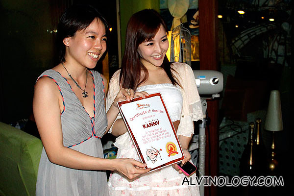 Blogger and actress, Kanny, being presented with a "certificate of bravery" from SOLD.sg