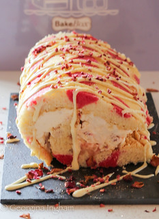 Georgina Ingham | Culinary Travels Photograph Bake Box Polka Dot Swiss Roll filled with Rose Petal Jam and Whipped Cream, topped with White Chocolate, Raspberries and Rose Petals