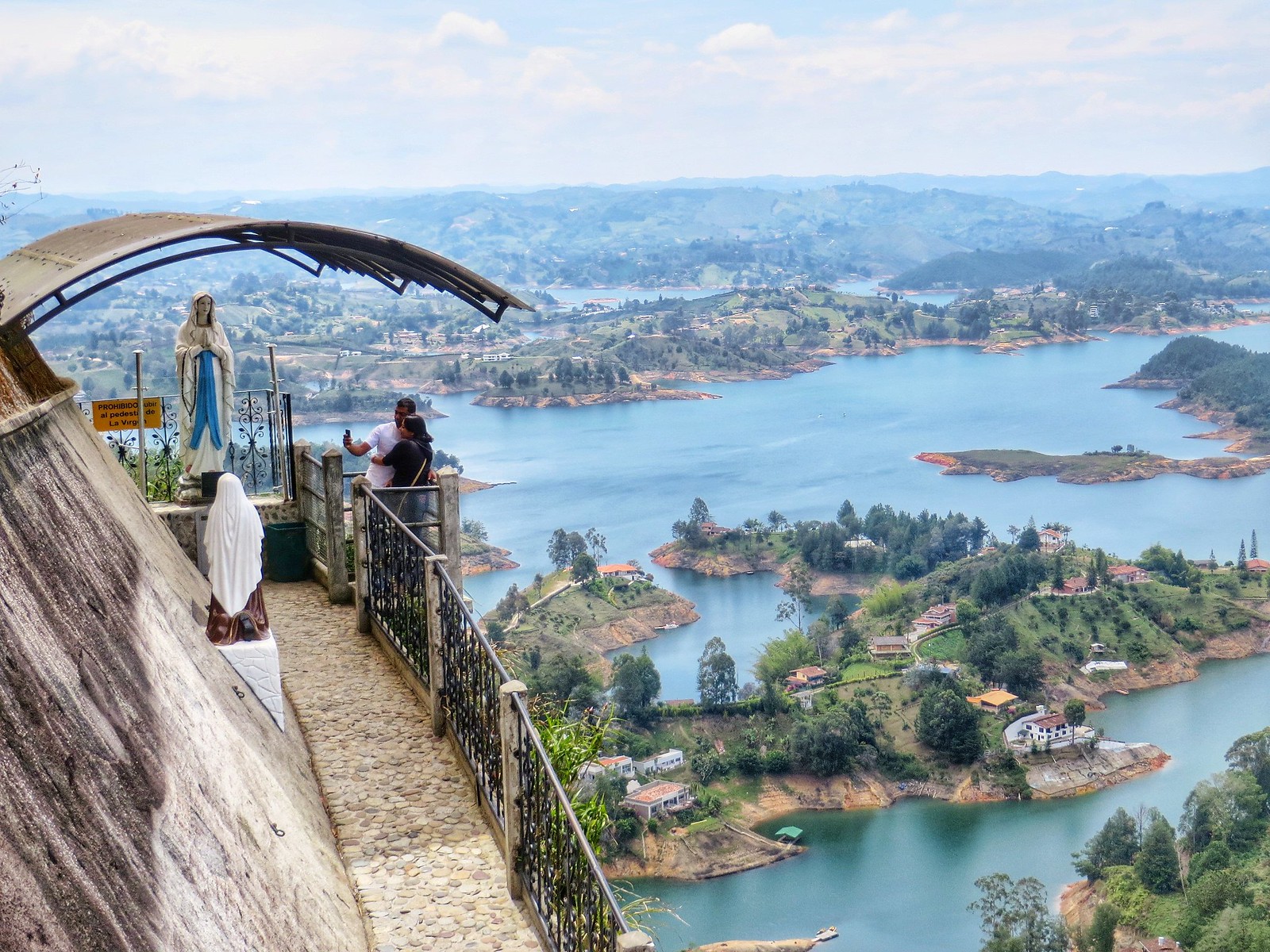 A couple taking photos above the Guatape lakes in Colombia