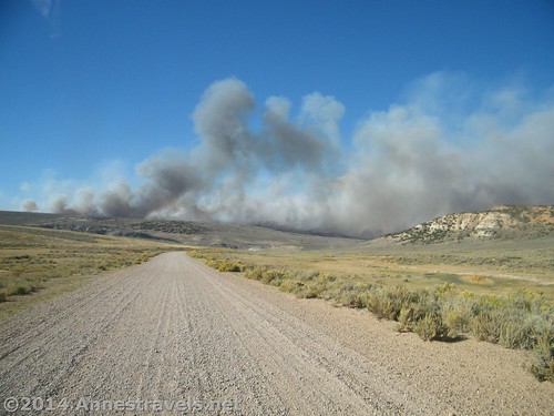 Smoke billows over I-80 - the road we're supposed to be driving on, in Wyoming