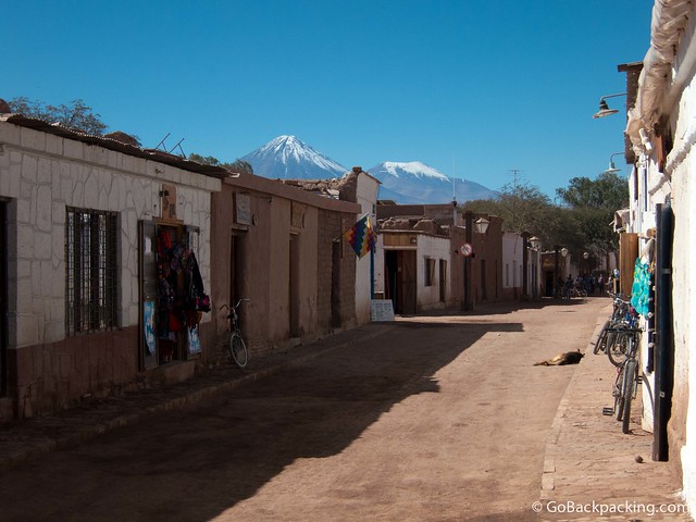 View of snow-capped volcanoes from the main tourist street in San Pedro de Atacama