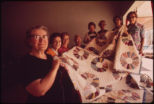 Members of the Golden Circle Senior Citizens Club of Fairmont holding quilt they made. The quilt was raffled off during the Fairmont centennial, May 1973