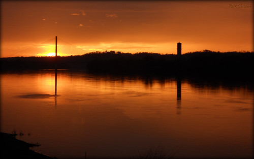 bridge sunset reflection silhouette yellow amber watertower wv westvirginia goldensunset ohioriver silhouettereflection calmwater huntingtonwv 31ststreetbridge rcvernors proctorvilleoh guyandottewv rickchilders eastendbridge sunsetinbutter