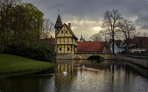 city bridge sunset house castle water yellow clouds germany dark town gate couple centre small rainy medival münsterland kasteel clouded steinfurt swanpair bobvandenberg zino2009