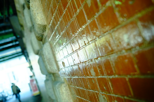 old brick wall underneath the elevated railway tracks