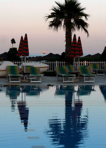blue sun sunlight pool palms dawn ship swimmingpool palmtrees albania umbrellas distant sunscape sunbeds durrës