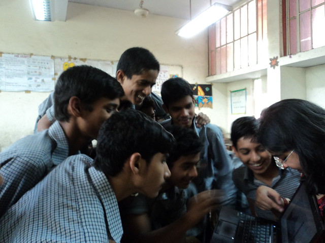 Showing photographs of religious harmony to students.