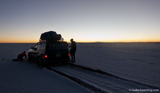 Our driver uses his hands to begin digging out the SUV in Salar de Uyuni.