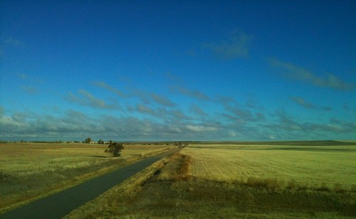 road blue sky clouds colorado farmland land wideopen