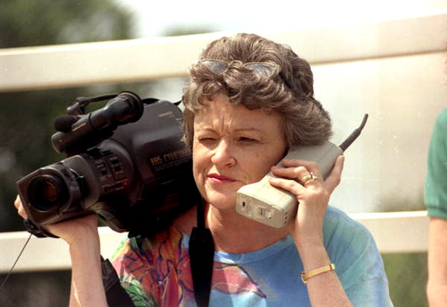 Journalist Lucy Morgan with video camera and phone