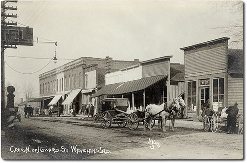 horses people usa signs man men history cars buildings walking advertising awning waveland clothing hats indiana streetscene transportation shops pedestrians hotels storefronts grocery automobiles businesses wagons barbers montgomerycounty realphoto hoosierrecollections