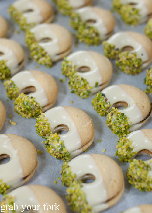 Shortbread biscuits dipped in white chocolate and pistachios at Bateel Date Factory, Dubai