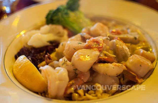Black Forest's Grilled prawns and scallops, artichoke hearts, and spaetzle served in herb Riesling sauce with red cabbage