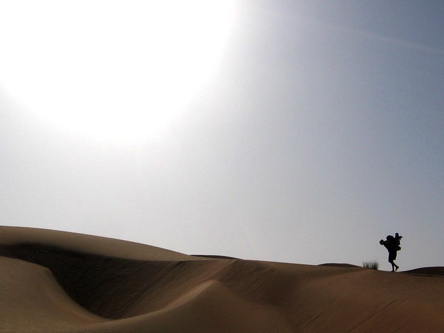 Sherpa-ing a heavy pack along a dune ridge