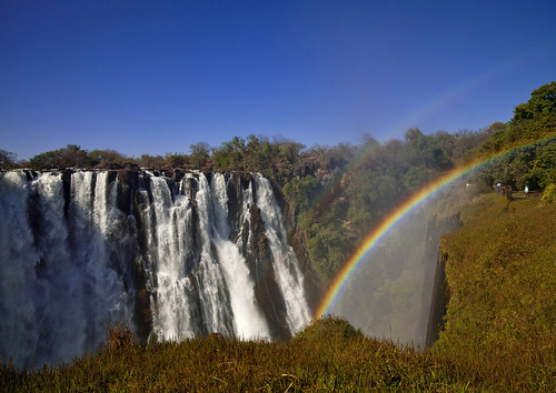 africa nature horizontal landscape outside outdoors rainbow exterior bluesky nopeople victoriafalls cascade zambia colorphoto livingstone southernafrica 694