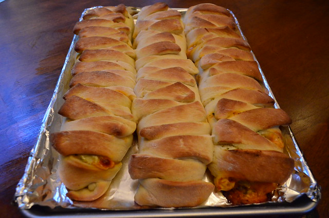 Three cooked Easy Chicken Pesto Calzone's on a baking sheet.