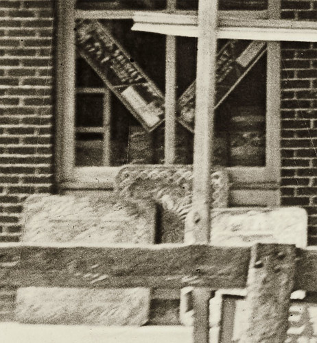 people usa signs man men history sepia buildings advertising clothing mail general postoffice indiana porch shops pedestrians storefronts businesses departmentstores clintoncounty realphoto michigantown hoosierrecollections