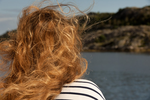 sea tourism water norway horizontal closeup outdoors island solitude day longhair curls tourist nordic rearview relaxation scandinavia tousled hairstyle vacations oneperson headandshoulders onewomanonly gettingawayfromitall focusonforeground caucasianappearance dyedredhair lookingatview