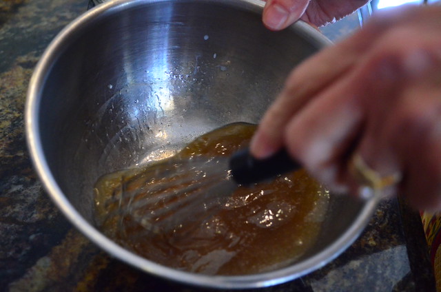 A separate bowl of wet ingredients being whisked together.