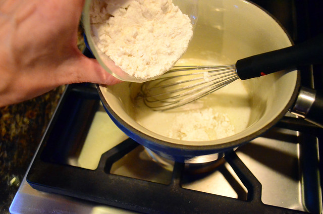 Preparing the bechamel in a small saucepan.