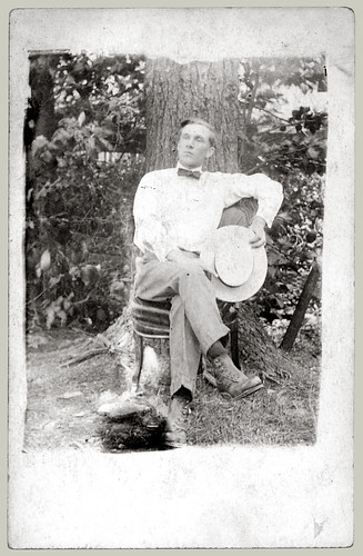 Seated man with hat