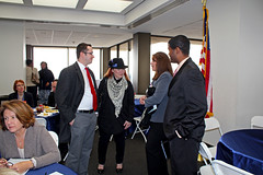 Deborah Moore speaking to Michael Lopez, another guest and Brian Sealey after the keynote event in the west wing of the twenty-second floor of the Capitol during Guardian ad Litem Day on February 9, 2012 in Tallahassee, Florida.
