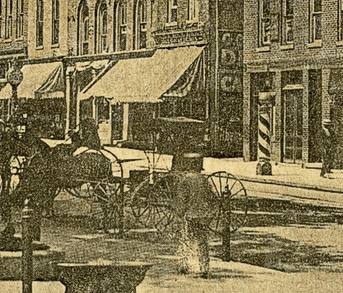 horses people woman usa signs man men history sepia buildings walking advertising awning clothing women indiana streetscene danville transportation drugs shops pedestrians storefronts grocery buggy buggies businesses barbers jeweler hendrickscounty hoosierrecollections