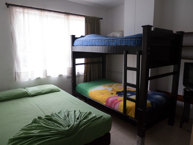 A typical room featuring a queen size bed and bunk bed 