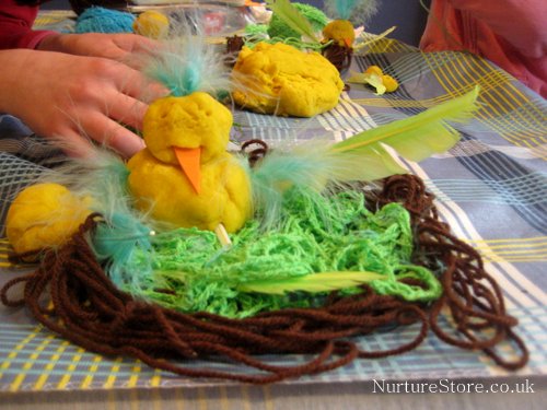 spring sensory bin with play dough and craft supplies