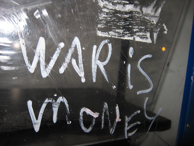 War is Money (Encourage people to consider how our socio-economic-cultural system incentivizes and rewards aggressions and other harmful behaviors/activities.)
