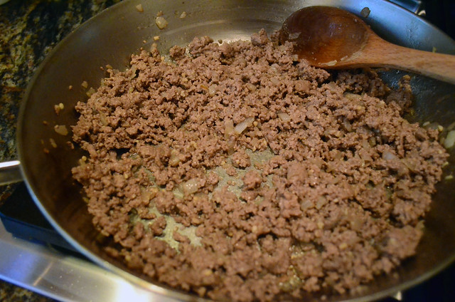 Ground beef is cooked in the skillet.
