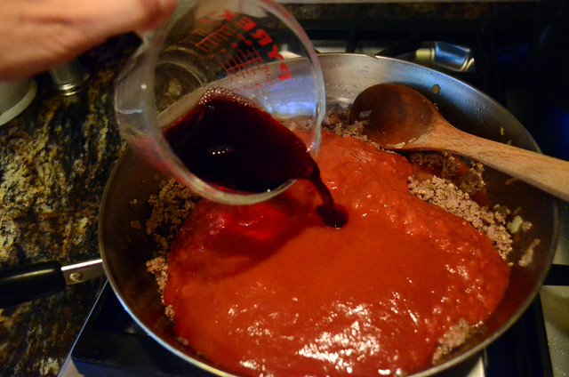 Red wine is poured into the skillet.