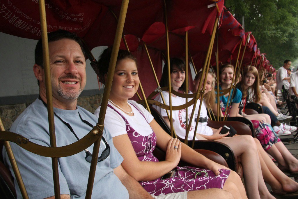 Spartanburg High School Symphony Orchestra students and parents on a rickshaw tour in Beijing
