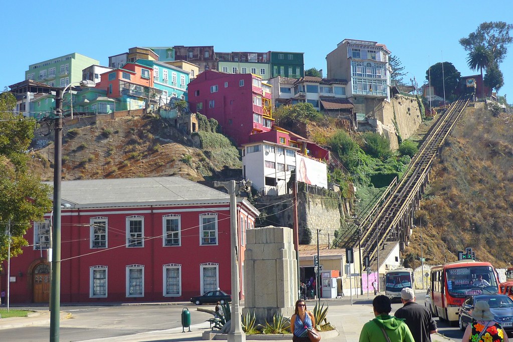 train lines going up a steep hill next to homes Cerro Artillería