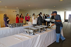 A Catering by Judy staff member prepares for the luncheon while others talk in the reception area of the twenty-second floor of the Capitol during Guardian ad Litem Day on February 9, 2012 in Tallahassee, Florida.