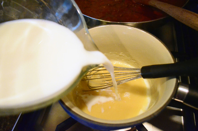 Milk is added to the bechamel.