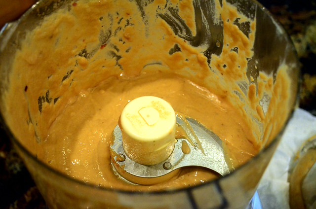 The dressing inside the food processor has become a smooth paste.