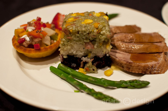 Sliced sweet soya braised duck breast, sautéed duck meat with diced vegetables on squash shell wild rice tower
