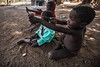 Children of ethnic lobi play with slingshots, Gaoua, burkina faso