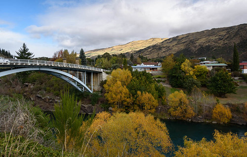 bridge autumn trees newzealand sky water clouds buildings river landscape hills southisland centralotago roxburgh cluthariver tripdownsouth teviotvalley